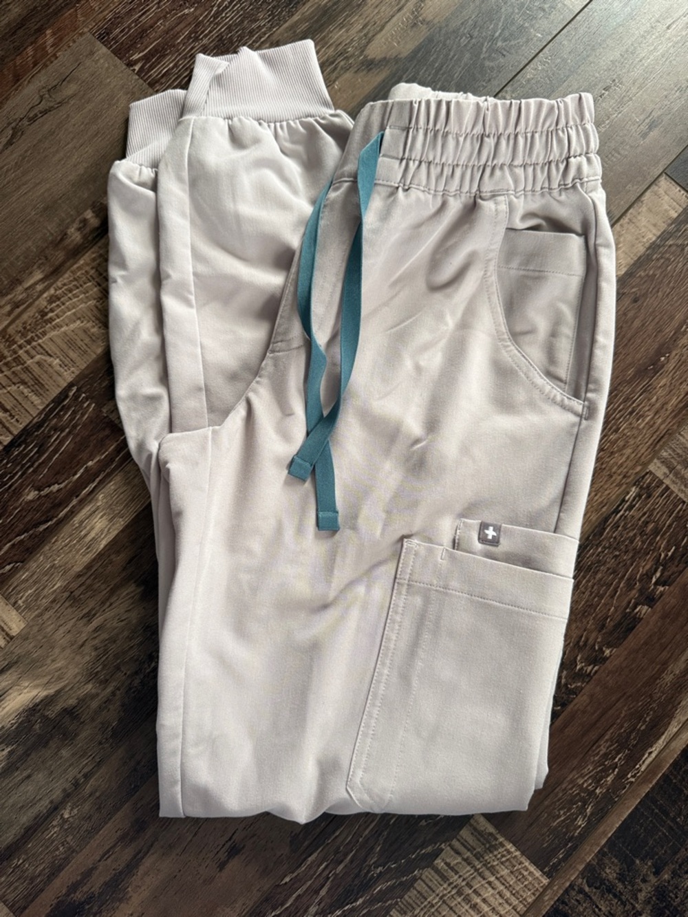 Figs women’s Light cream/tan colored Jogger Scrub Pants with Teal Drawstring